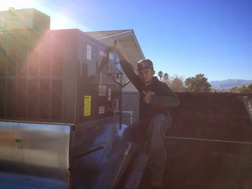 HVAC technician performing Boiler Repair on a rooftop unit in Brook Highland